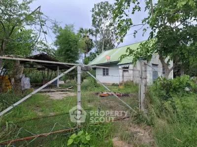Charming rural property with lush greenery and rustic exterior, perfect for countryside living.
