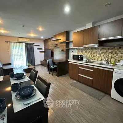 Modern open-layout kitchen and living area with stylish decor and appliances
