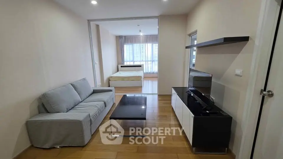 Modern open-plan living room with sleek furniture and natural light