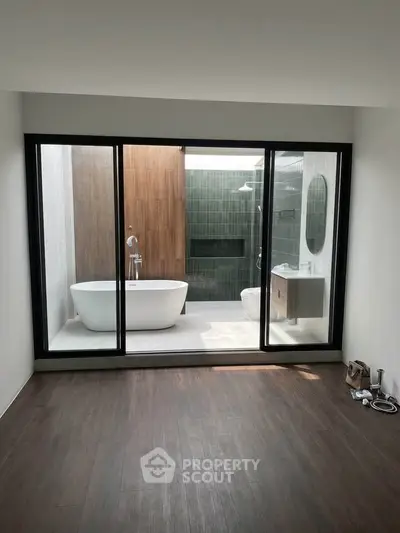 Luxurious bathroom with modern freestanding bathtub and elegant glass partition.