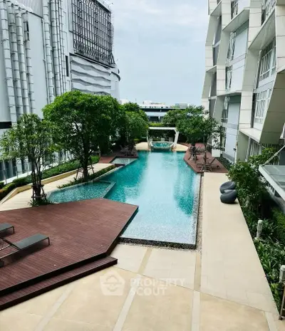 Luxurious modern apartment complex with stunning pool and lush greenery