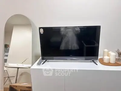 Modern living room with sleek TV setup and stylish decor elements.