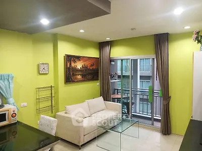 Modern living room with vibrant green walls, cozy sofa, and balcony access in urban apartment.