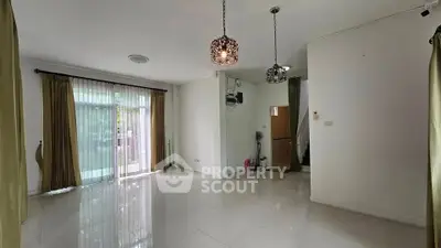 Spacious living room with elegant lighting and large windows for natural light.