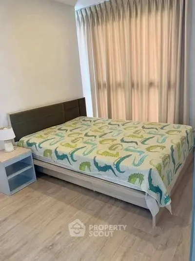 Cozy bedroom with modern decor and large window, perfect for relaxation and comfort.
