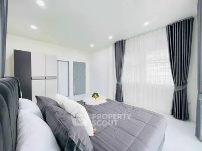 Spacious modern bedroom with elegant decor and natural light