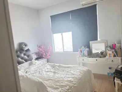 Cozy bedroom with soft lighting, stylish headboard, and elegant dresser, perfect for relaxation and comfort.