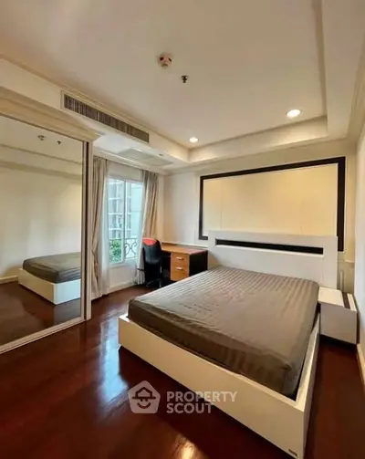 Modern bedroom with sleek design and large mirror wardrobe