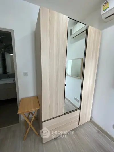 Modern bedroom with sleek wardrobe and air conditioning unit