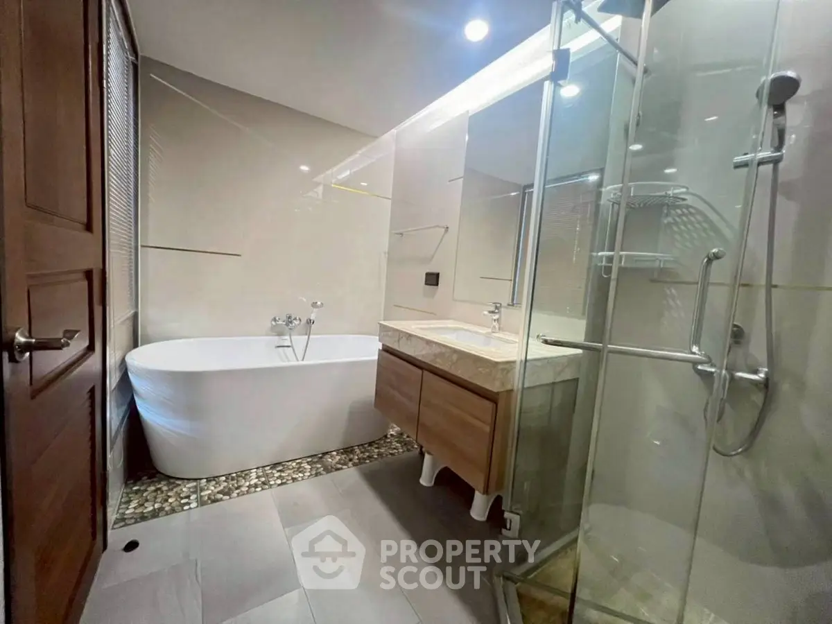 Luxurious bathroom with modern fixtures and elegant freestanding bathtub.