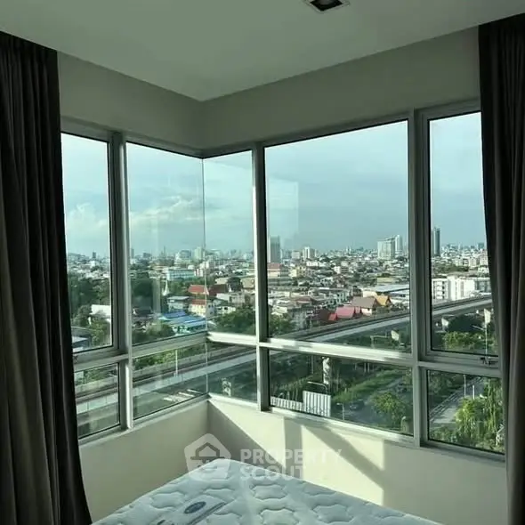 Stunning corner unit bedroom with panoramic city views and abundant natural light.