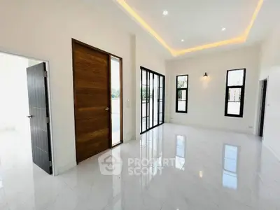 Spacious modern living room with high ceilings and large windows