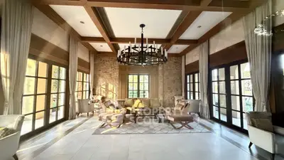 Luxurious living room with elegant decor and large windows offering abundant natural light.