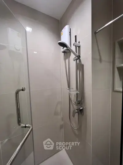 Modern bathroom shower with sleek fixtures and neutral tiles