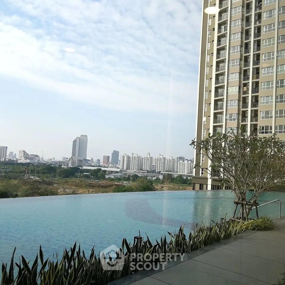 Luxurious high-rise apartment with stunning infinity pool and city skyline view.