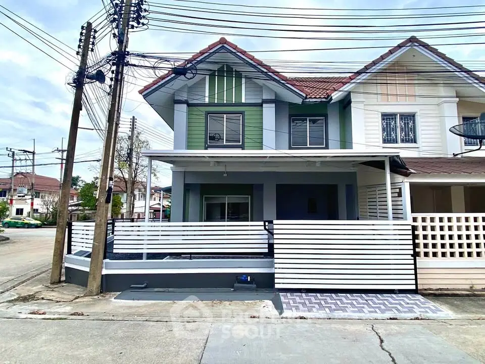 Charming two-story house with modern facade and spacious driveway in suburban neighborhood.
