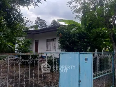 Charming single-story home with lush garden and gated entrance, perfect for serene living.