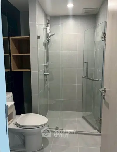 Modern bathroom with glass shower enclosure and sleek tile design