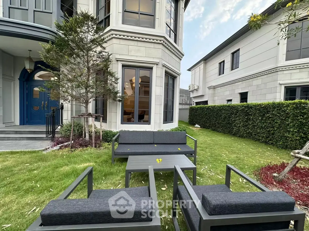 Elegant garden with modern outdoor seating in luxurious residential property