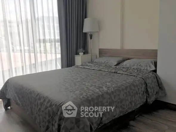 Modern bedroom with elegant decor and large window for natural light