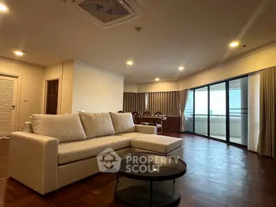 Spacious living room with elegant decor and large balcony view
