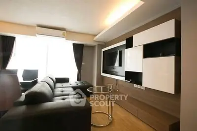 Modern living room with sleek furniture and built-in entertainment center