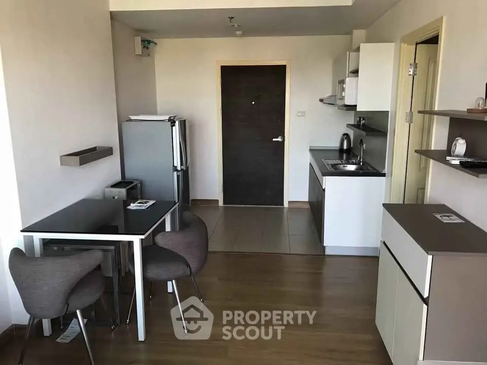 Modern apartment kitchen with dining area and sleek appliances