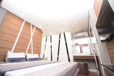 Modern bedroom with stylish wood paneling and sleek design elements.