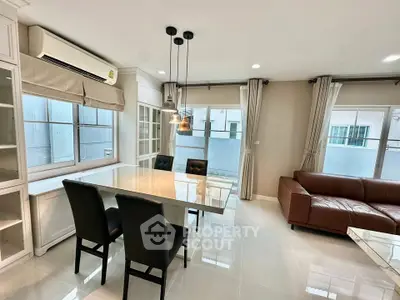 Spacious modern living room with elegant dining area and large windows