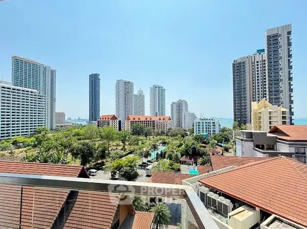 Stunning cityscape view from a high-rise balcony overlooking lush greenery and modern skyscrapers.