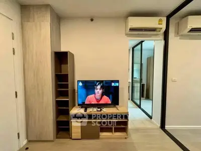 Modern living room with sleek TV stand and air conditioning in a stylish apartment.