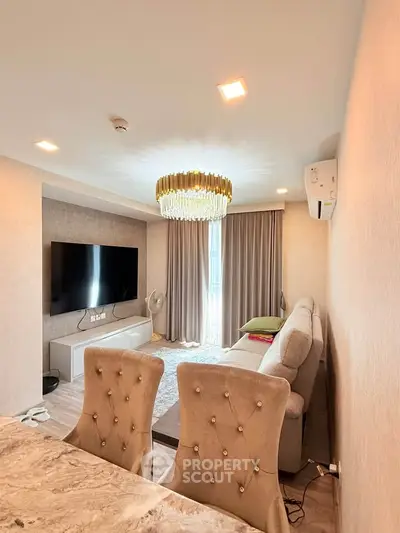 Luxurious living room with elegant chandelier and modern decor in a high-end apartment.