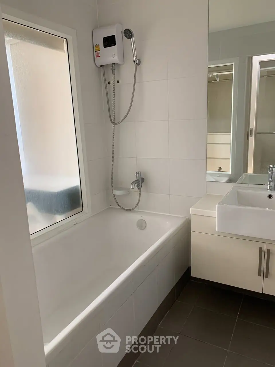 Modern bathroom with bathtub and sleek fixtures in a contemporary home.