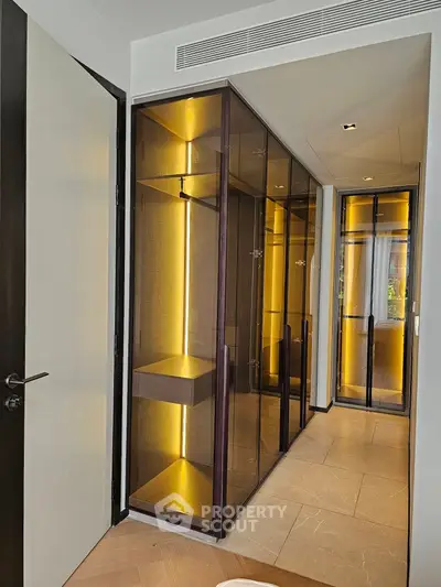 Luxurious walk-in closet with elegant lighting and modern design
