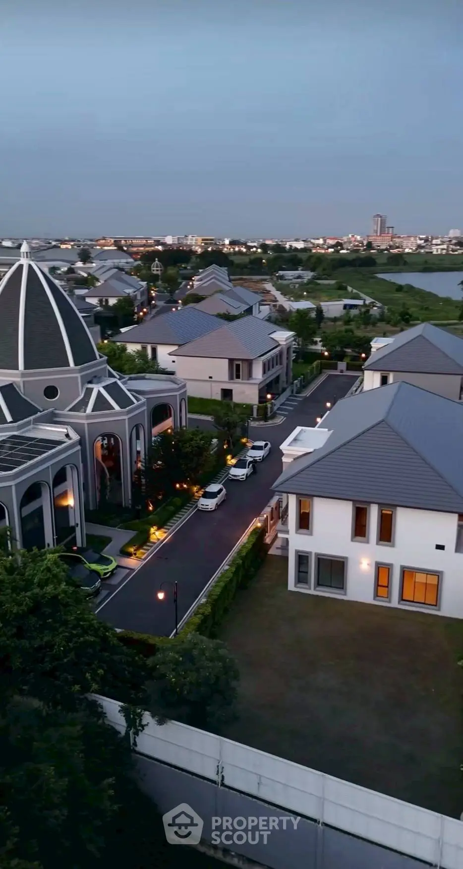 Stunning aerial view of a modern residential neighborhood at dusk, showcasing elegant architecture and serene surroundings.