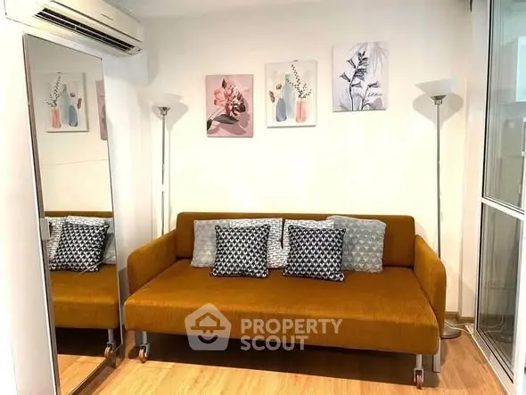 Stylish living room with modern sofa, decorative pillows, and elegant wall art.