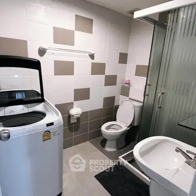 Modern bathroom with washing machine and shower in stylish apartment.