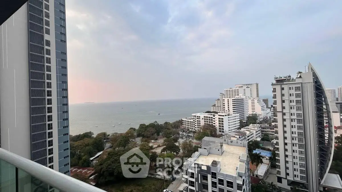 Stunning ocean view from high-rise balcony overlooking cityscape and coastline.