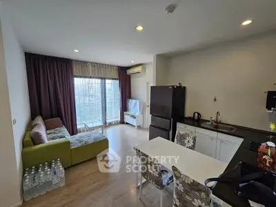 Modern living room with open kitchen, featuring a cozy sofa and dining area, ideal for urban living.