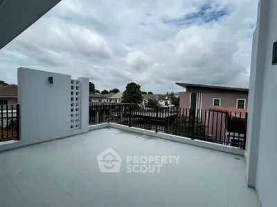 Spacious balcony with modern railing and scenic neighborhood view, perfect for relaxation and outdoor activities.