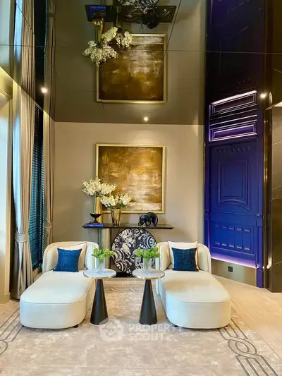 Luxurious living room with elegant decor and plush seating, featuring high ceilings and sophisticated artwork.