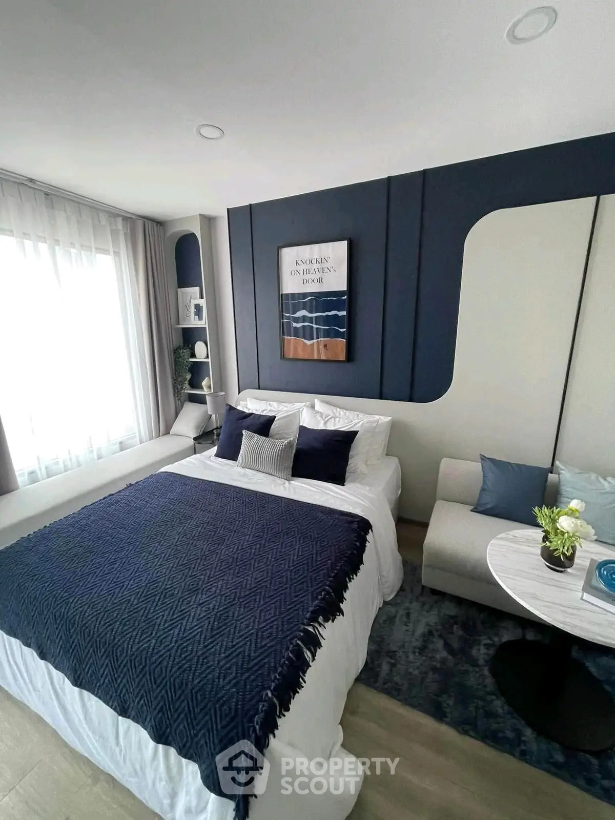 Stylish modern bedroom with elegant decor and cozy seating area