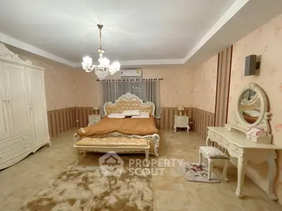 Luxurious vintage-style bedroom with elegant chandelier and ornate furniture