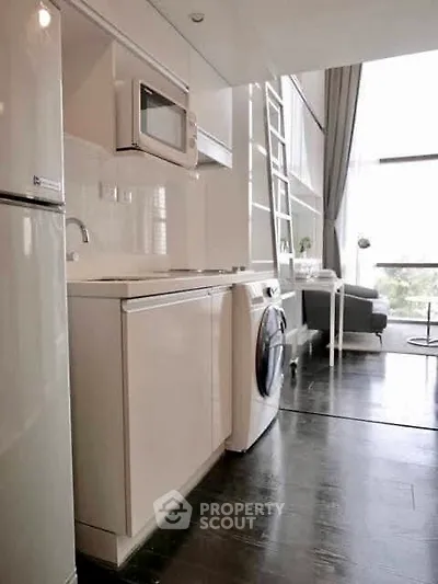 Modern kitchen with sleek appliances and open layout in stylish apartment