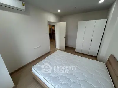 Spacious bedroom with modern design and ample storage in a stylish apartment.