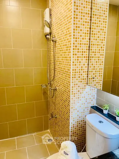 Modern bathroom with stylish tiles and shower in a real estate property.
