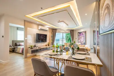Luxurious open-plan living and dining area with elegant decor and modern lighting.