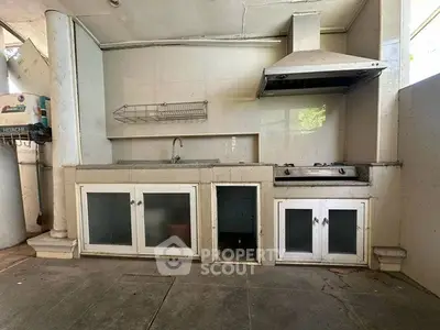 Spacious kitchen with modern gas stove and ample storage space