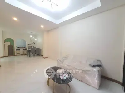 Spacious modern living room with sleek marble flooring and elegant furniture.