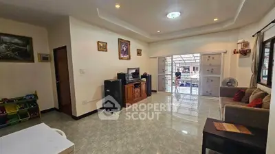Spacious living room with modern decor and large windows for natural light.